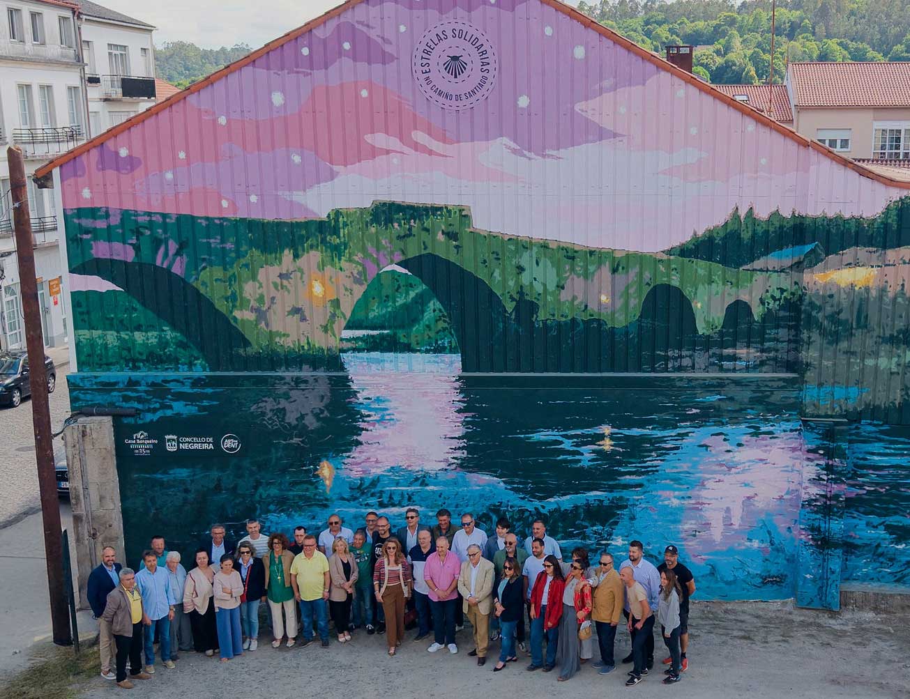 As 25 estrelas de Casa Barqueiro iluminan Negreira: Fernando Yáñez inmortaliza Ponte Maceira nun mural solidario